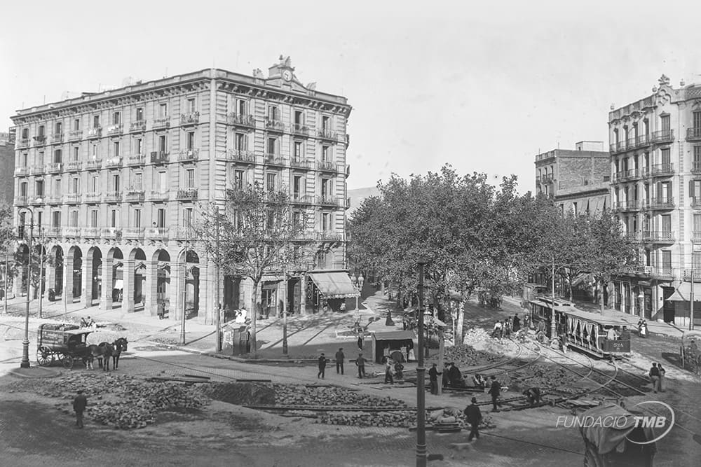 Avenida del Paral·lel con Ronda de Sant Pau, 1904. Instalación de vía para la ampliación de las líneas que circularían por la avenida del Paral·lel. En la imagen se ve un tranvía eléctrico con remolque jardinera. El servicio de tranvía eléctrico en Barcelona se inauguró el 26 de enero de 1899. La electrificación impulsó la creación de nuevas líneas en la ciudad. Los primeros tranvías eléctricos tenían que circular a una velocidad máxima de 8 kilómetros por hora, salvo el tramo de recorrido por el Eixample, que podían aumentar la velocidad hasta 12 km.